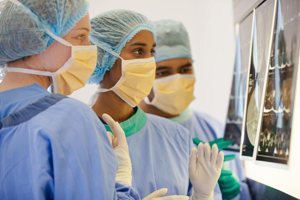 Surgeons examining x-rays in operating room