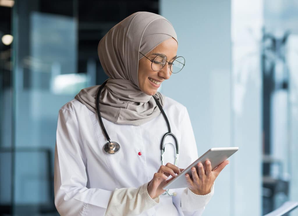 Female doctor in hijab works in modern clinic office